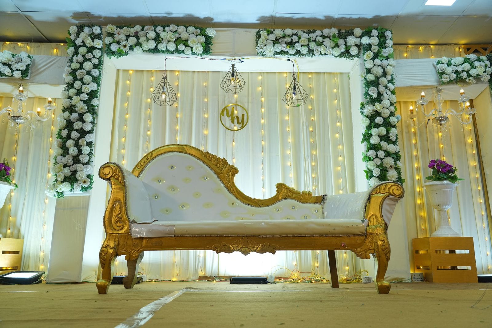The stage at Kongu Kalaiarangam, dressed in white and gold