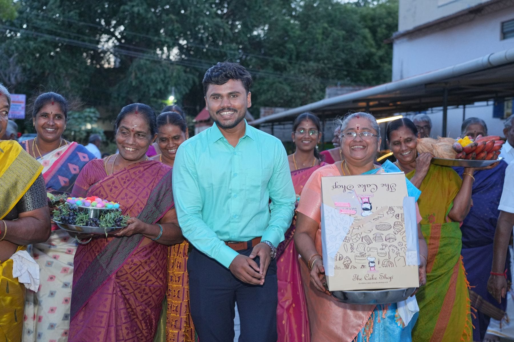 The family walking the trays through the street