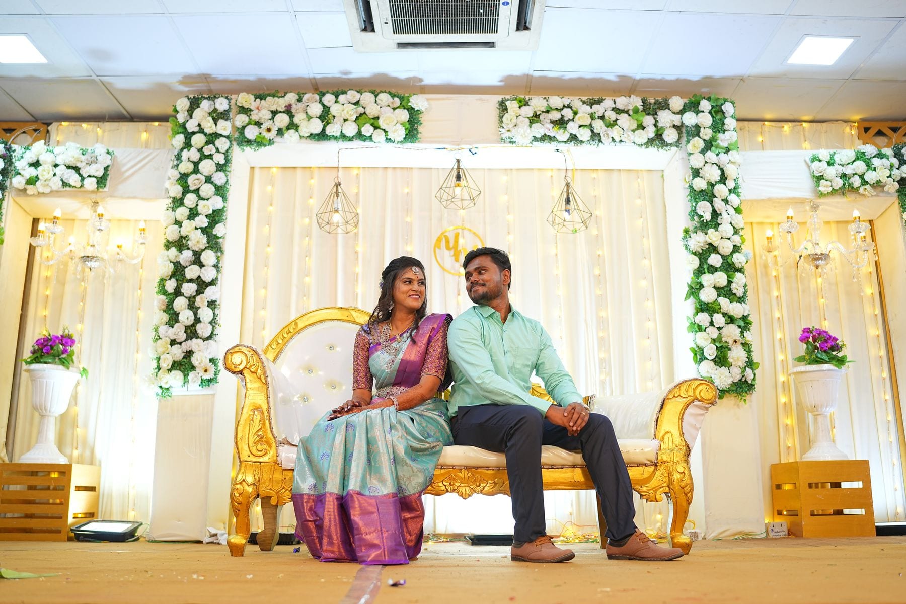 The two of them on the stage, the hall around them